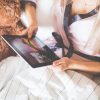 Girl Holding an iPad in Bed