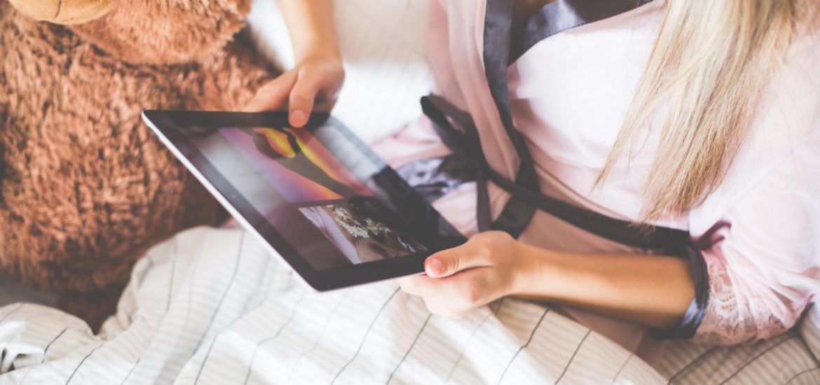 Girl Holding an iPad in Bed