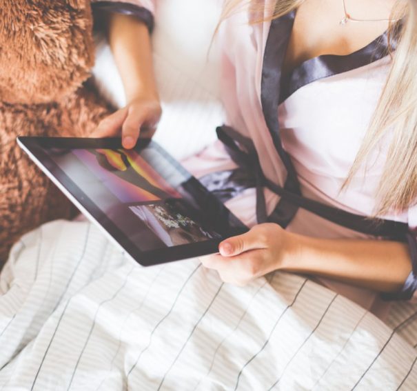 Girl Holding an iPad in Bed